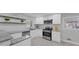 Bright kitchen with stainless steel appliances, granite countertops, and white cabinetry at 2480 Miriam Ln, Decatur, GA 30032
