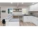 Well-lit kitchen featuring white cabinets, granite countertops, and a breakfast bar, perfect for modern living at 2480 Miriam Ln, Decatur, GA 30032