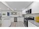 Open-concept kitchen features modern appliances, stone countertops, and a breakfast bar at 2480 Miriam Ln, Decatur, GA 30032