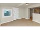 Light-filled living room features tile flooring, window, neutral wall color, and entrance door at 2480 Miriam Ln, Decatur, GA 30032