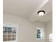 Bright room with neutral paint, modern lighting and two windows at 2480 Miriam Ln, Decatur, GA 30032
