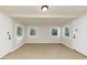 Room with three windows, tile floor, neutral walls, and two entry doors at 2480 Miriam Ln, Decatur, GA 30032