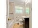 This bathroom has a modern vanity, mirror, and stylish tile at 4639 Tell Sw Rd, Atlanta, GA 30331