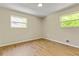 This bedroom has wood-look floors and two bright windows at 4639 Tell Sw Rd, Atlanta, GA 30331