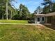 View of backyard showing the sunny lawn and trees at 6389 Cumberland Dr, Rex, GA 30273