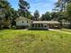Exterior shot of the home, highlighting the back patio and spacious yard at 6389 Cumberland Dr, Rex, GA 30273