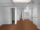 Basement featuring vinyl flooring, a closet, and a kitchenette with white appliances and cabinets at 6389 Cumberland Dr, Rex, GA 30273