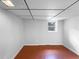 Finished basement area with vinyl flooring and a window offers natural light and potential for various uses at 6389 Cumberland Dr, Rex, GA 30273