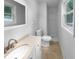 Bright bathroom featuring a vanity, standard toilet, and a shower with white tile walls at 6389 Cumberland Dr, Rex, GA 30273