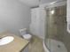 Bathroom featuring a glass-enclosed shower, built-in cabinet, and a standard toilet at 6389 Cumberland Dr, Rex, GA 30273