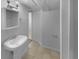 Cozy bathroom featuring a pedestal sink, neutral tile flooring, and a small medicine cabinet at 6389 Cumberland Dr, Rex, GA 30273