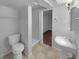 Basement bathroom featuring a toilet, pedestal sink, and a shower stall; ideal for guests at 6389 Cumberland Dr, Rex, GA 30273