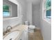 Bright bathroom featuring a vanity, standard toilet, and a shower with white tile walls at 6389 Cumberland Dr, Rex, GA 30273