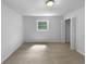 Empty bedroom with plush carpet, a window, and a closet for storage at 6389 Cumberland Dr, Rex, GA 30273
