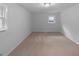 Cozy bedroom featuring neutral walls, carpet flooring, and a window providing natural light at 6389 Cumberland Dr, Rex, GA 30273