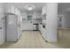 Well-lit kitchen with white cabinetry, tile floors, and stainless steel appliances at 6389 Cumberland Dr, Rex, GA 30273
