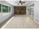 Spacious living room with a brick fireplace, tile floors, and lots of natural light at 6389 Cumberland Dr, Rex, GA 30273