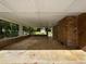 Covered patio featuring brick columns and concrete flooring, perfect for outdoor relaxation at 6389 Cumberland Dr, Rex, GA 30273