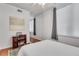 A bright bedroom features hardwood floors, a ceiling fan, and a workstation at 800 Peachtree Ne St # 101, Atlanta, GA 30308