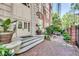 Building entrance with greenery and outdoor seating at 800 Peachtree Ne St # 101, Atlanta, GA 30308