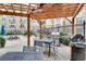 Outdoor grill area with dining tables and views of the pool at 800 Peachtree Ne St # 101, Atlanta, GA 30308