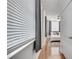 Hallway leading to a bedroom with hardwood floors, window blinds and bright neutral paint at 800 Peachtree Ne St # 101, Atlanta, GA 30308