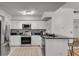 Modern kitchen with stainless steel appliances, granite countertops, and white cabinetry at 800 Peachtree Ne St # 101, Atlanta, GA 30308