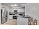 Modern kitchen with stainless steel appliances, granite countertops, and stylish seating at the breakfast bar at 800 Peachtree Ne St # 101, Atlanta, GA 30308