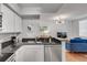 Contemporary kitchen with stainless steel appliances, granite countertops, and an open view to the living room at 800 Peachtree Ne St # 101, Atlanta, GA 30308