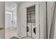 A laundry area features a washer, dryer, and storage shelves at 800 Peachtree Ne St # 101, Atlanta, GA 30308