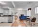 Spacious living area adjacent to the kitchen, featuring modern decor and a dining setup at 800 Peachtree Ne St # 101, Atlanta, GA 30308