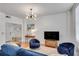 Bright living room with hardwood floors, modern lighting, and comfortable blue seating at 800 Peachtree Ne St # 101, Atlanta, GA 30308