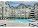 A large outdoor swimming pool is surrounded by lounge chairs at 800 Peachtree Ne St # 101, Atlanta, GA 30308