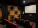 Home theater room with black walls, acoustic panels, and comfortable red seating at 800 Peachtree Ne St # 101, Atlanta, GA 30308