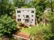 Expansive aerial view showcasing the home's backyard with a deck, balcony, and landscaping, surrounded by lush trees at 1327 Harvard Ne Rd, Atlanta, GA 30306