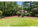 Backyard with green grass, trees and fenced entrance to property at 1327 Harvard Ne Rd, Atlanta, GA 30306