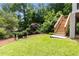 Backyard featuring lush green grass, and wooden stairs to upper porch at 1327 Harvard Ne Rd, Atlanta, GA 30306