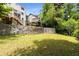 Large backyard with stone wall featuring multiple home elevations in background at 1327 Harvard Ne Rd, Atlanta, GA 30306