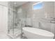 Luxurious bathroom featuring a freestanding tub, glass shower, and modern tilework for a spa-like retreat at 1327 Harvard Ne Rd, Atlanta, GA 30306