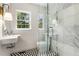 Modern bathroom with glass shower, black and white tile floor, and stylish fixtures at 1327 Harvard Ne Rd, Atlanta, GA 30306