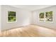 Bright bedroom with hardwood floors and two large windows offering scenic outdoor views at 1327 Harvard Ne Rd, Atlanta, GA 30306