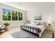 Bright primary bedroom featuring hardwood floors, large windows with backyard view, and simple decor at 1327 Harvard Ne Rd, Atlanta, GA 30306