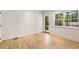 Bright, empty bedroom with hardwood floors, a door to the outside, and large windows offering ample natural light at 1327 Harvard Ne Rd, Atlanta, GA 30306