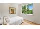 Bright bedroom featuring a large window with a view of the lush greenery outside at 1327 Harvard Ne Rd, Atlanta, GA 30306