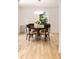 Bright dining room with hardwood floors, a modern chandelier, and natural light from the window at 1327 Harvard Ne Rd, Atlanta, GA 30306