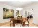 Elegant dining room featuring hardwood floors, a classic wood table, designer lighting, and an archway at 1327 Harvard Ne Rd, Atlanta, GA 30306
