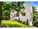 Charming white brick home with a well-manicured lawn and mature trees at 1327 Harvard Ne Rd, Atlanta, GA 30306