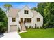 Attractive white brick home with manicured lawn, a garage and inviting entryway at 1327 Harvard Ne Rd, Atlanta, GA 30306