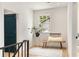 Hallway with hardwood floors, a wooden bench, and a view of the home's exterior through a window at 1327 Harvard Ne Rd, Atlanta, GA 30306