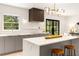 Bright kitchen featuring an island with bar stools, modern cabinetry, and quartz countertops at 1327 Harvard Ne Rd, Atlanta, GA 30306